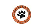 an orange and white logo with a dog's paw